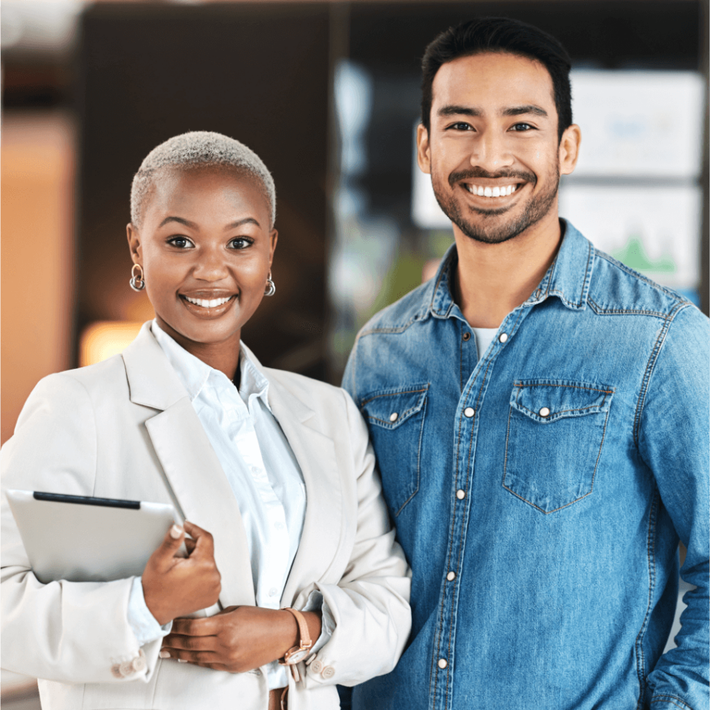 Professional woman and man smiling in office setting.