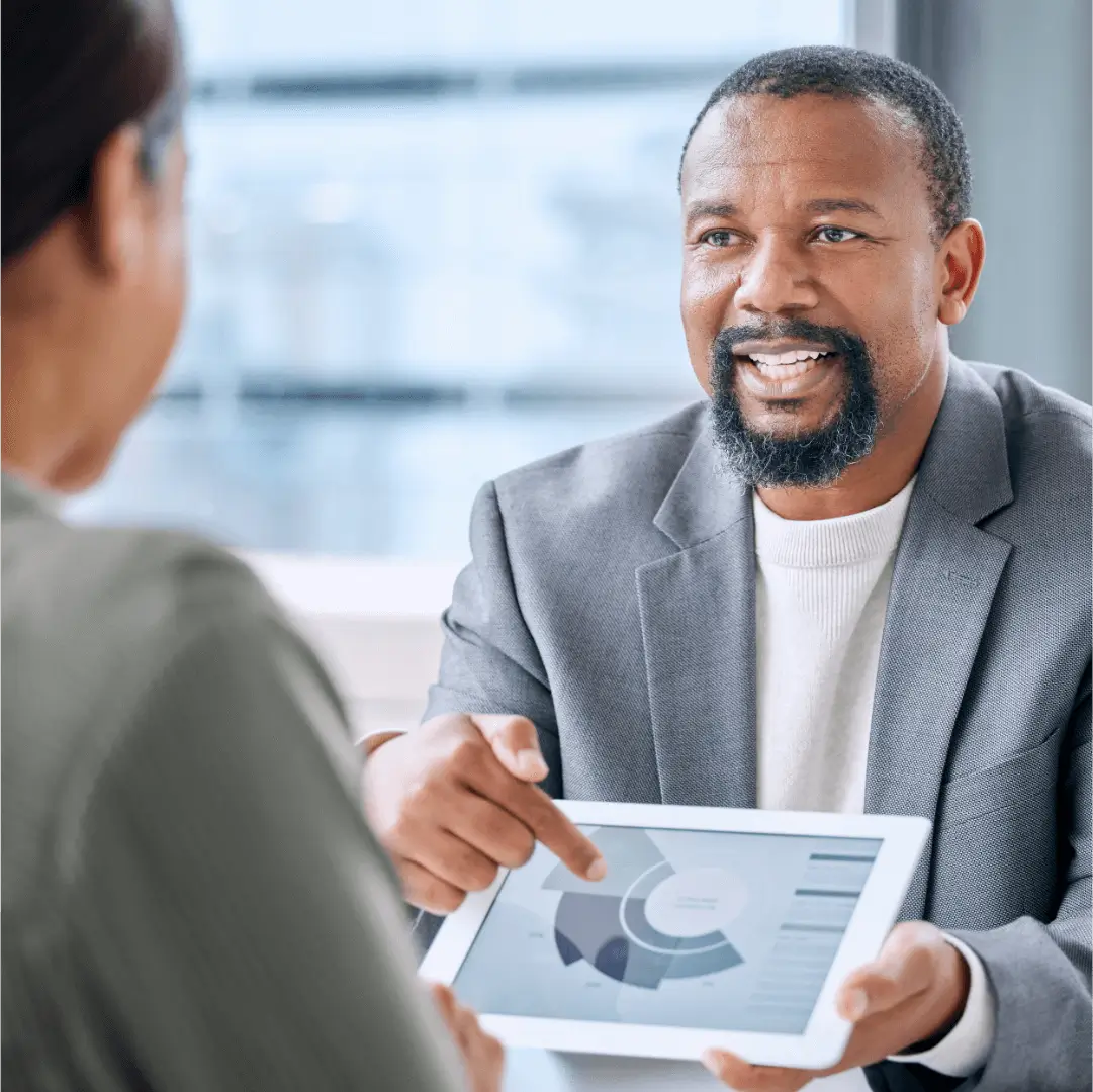 Businessman discussing chart with colleague during meeting.
