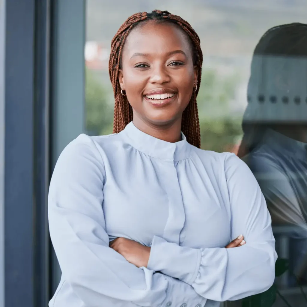 Confident businesswoman smiling with arms crossed.