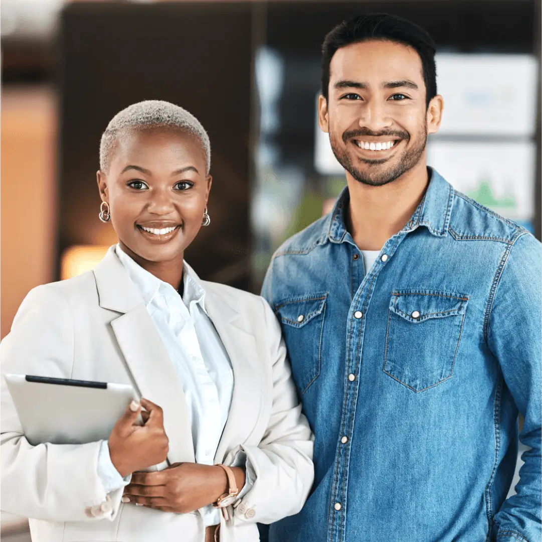 Two professionals smiling in office setting.
