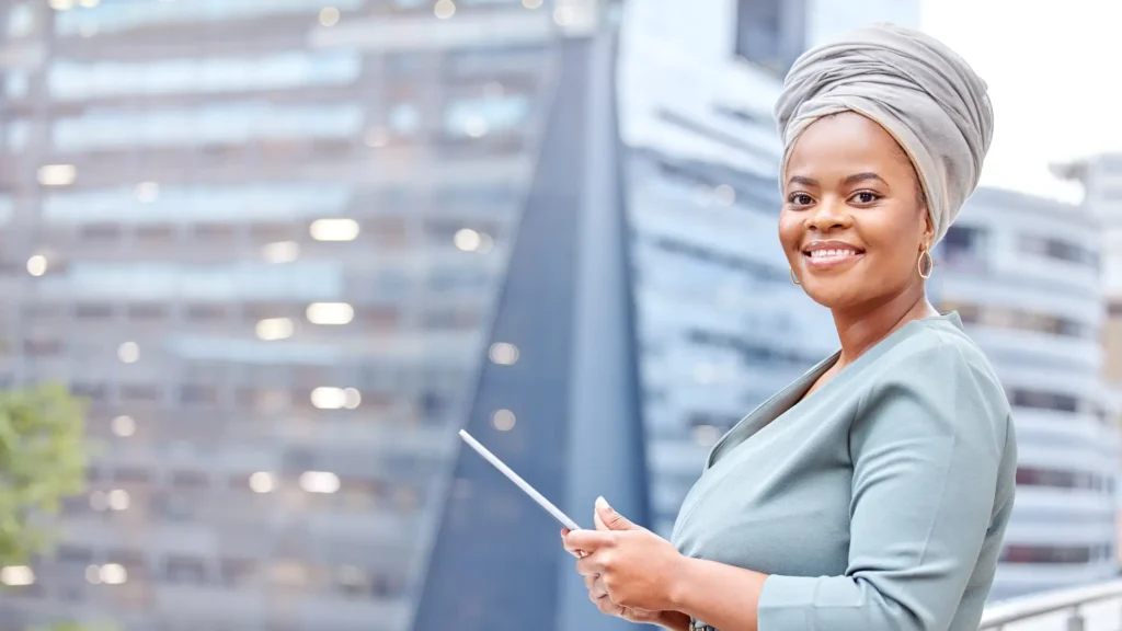 Smiling woman with tablet in urban setting.